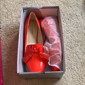 Bright orange loafers with classy tassles